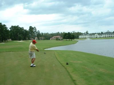 18th hole, par 5 with water along the right and an island green.  Dad before impact....
