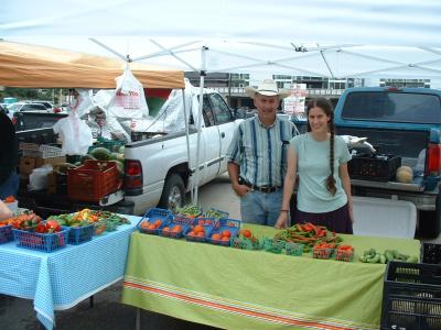 Rod Ardoin and daughter with green beans, tomatoes, peppers, and cantaloupe